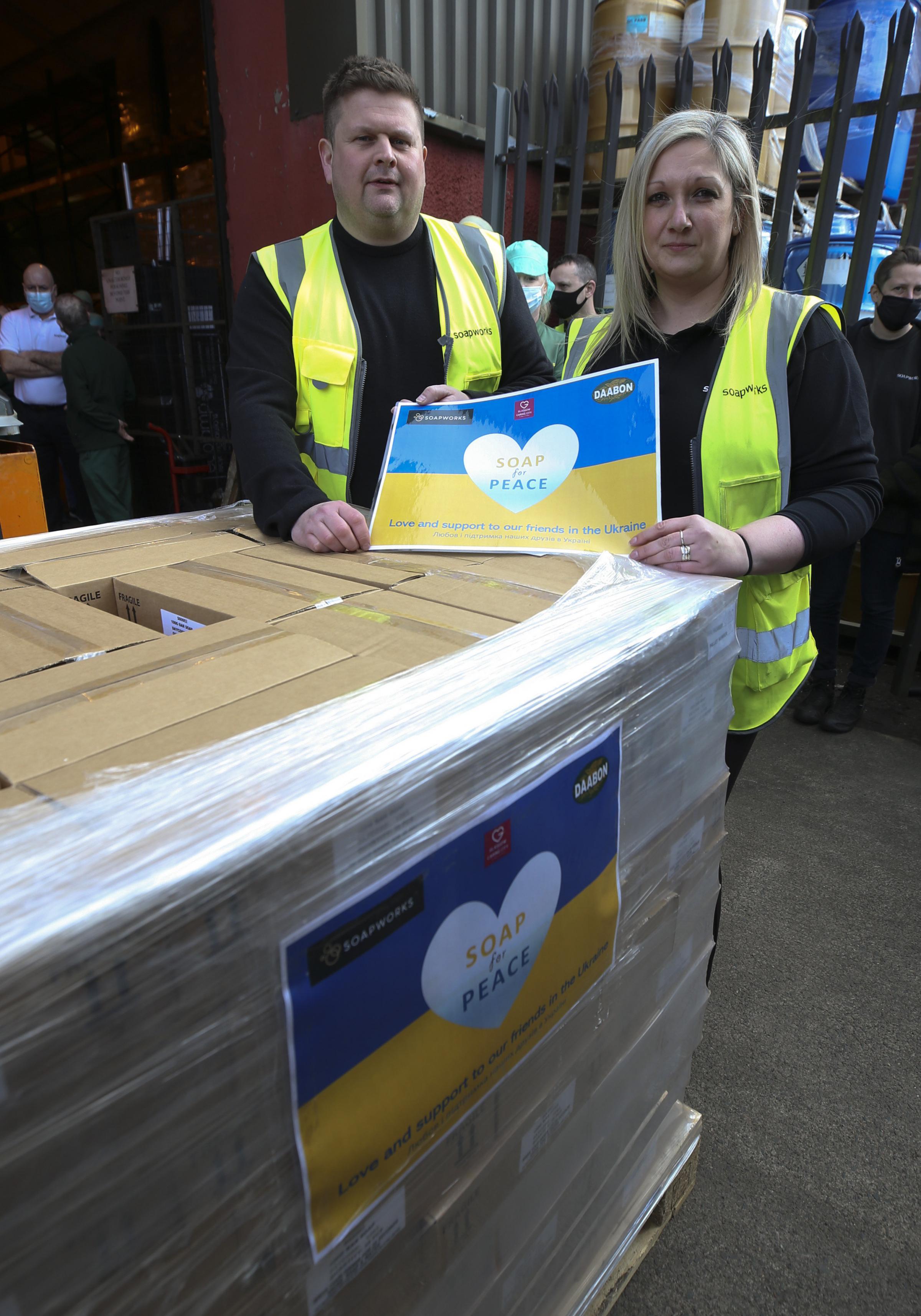 An aid lorry organised by Glasgow the Caring City with 47,000 bars of soap leaves the warehouse at Soapworks in the city heading for Ukraines refugees on the Polish border. Pictured is Ross Galbraith, from the charity, and warehouse supervisor Debbie