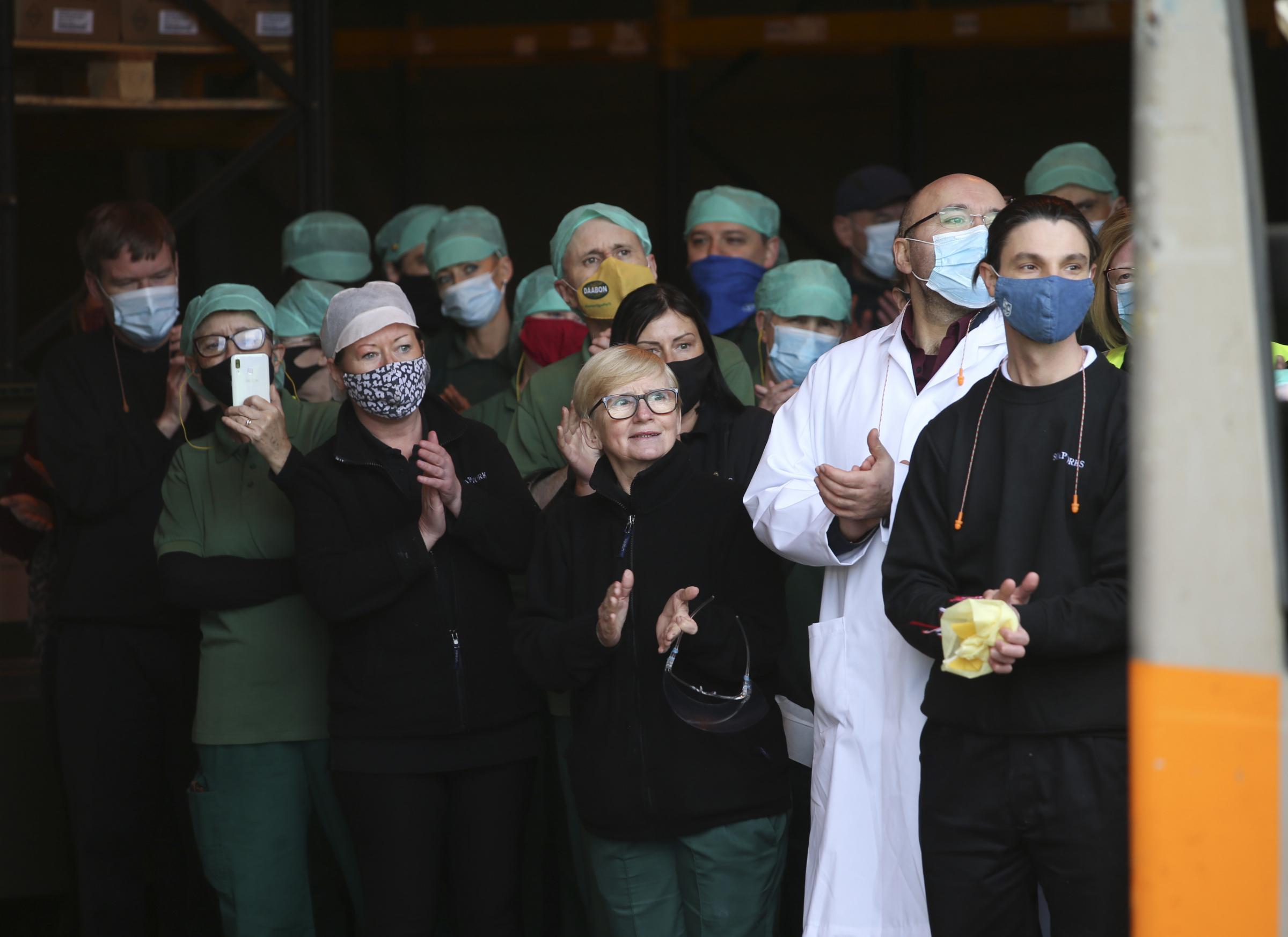 Staff from the warehouse at Soapworks look on as supplies are loaded and bound for Ukraine