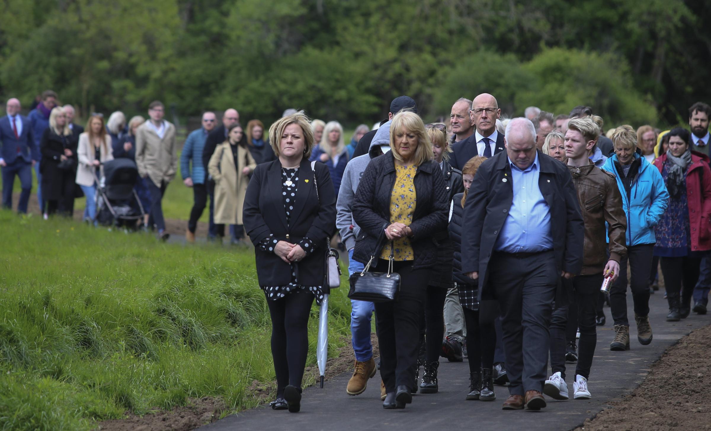 Families on a silent memorial walk