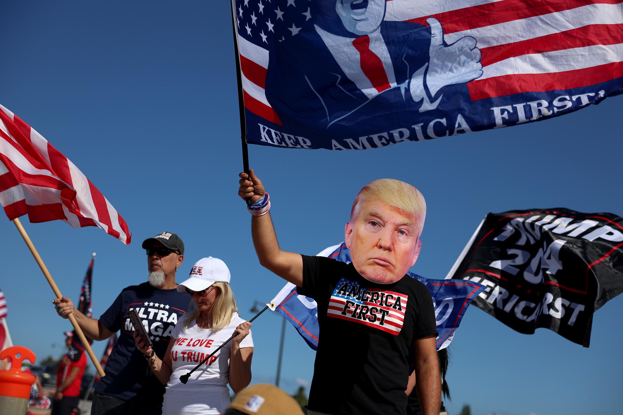 PALM BEACH, FLORIDA - MARCH 21: Justin Nezarez (R) shows his support for former President Donald Trump near his Mar-a-Lago home on March 21, 2023 in Palm Beach, Florida. Trump said on a social media post that he expects to be arrested in connection with