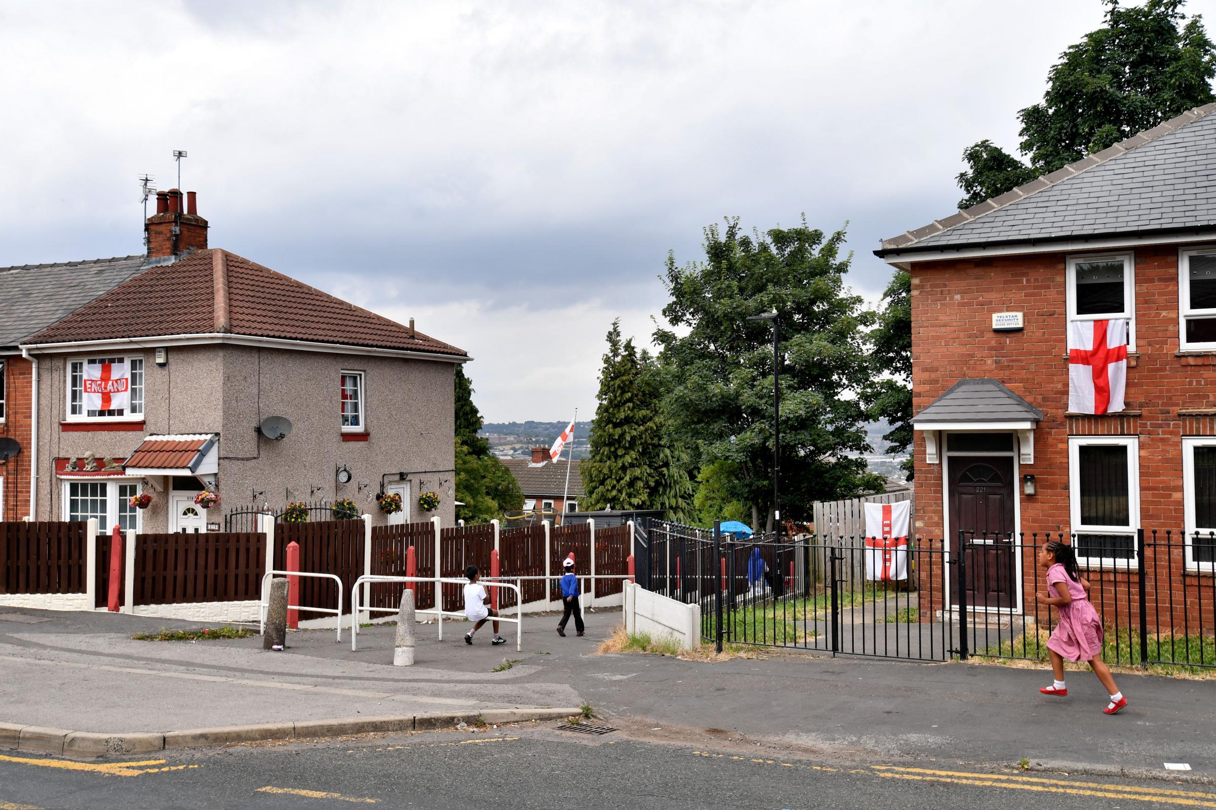 England flags decorate houses in Sheffield, northern England, on July 9, 2018 the birthplace of Englands Kyle Walker, Harry Maguire and Jamie Vardy, three members of the England national football squad that will play against Croatia on July 11 for a