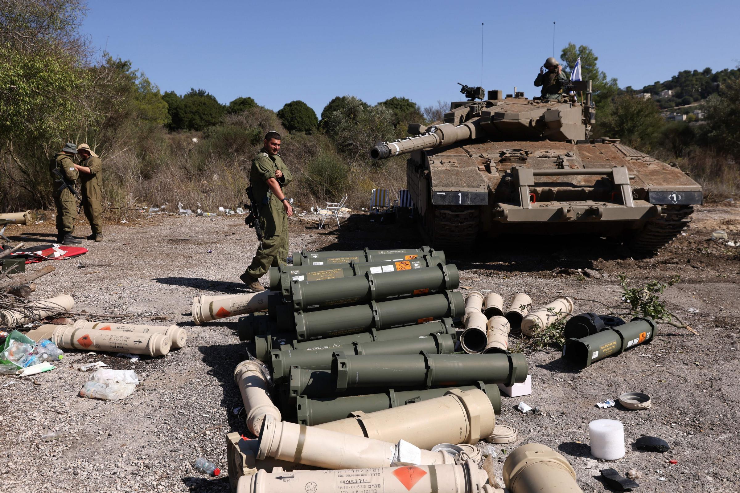 Israeli soldiers stand near a Merkava tank as they man a position at an undisclosed location on the border with Lebanon on October 21, 2023. Lebanons Iran-backed Hezbollah and allied Palestinian factions have traded cross-border fire with Israel for