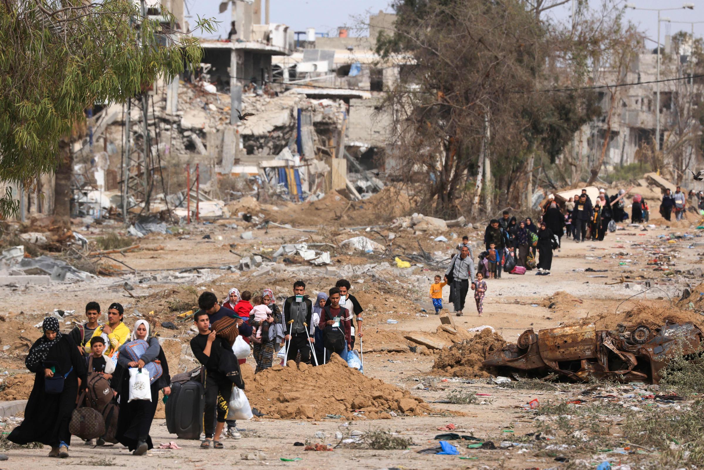 Palestinians leaving the north walk through the Salaheddine road in the Zeitoun district on the southern outskirts of Gaza City on November 25, 2023, on the second day of a truce between Israel and Hamas. Hamas is expected to release another 14 Israeli