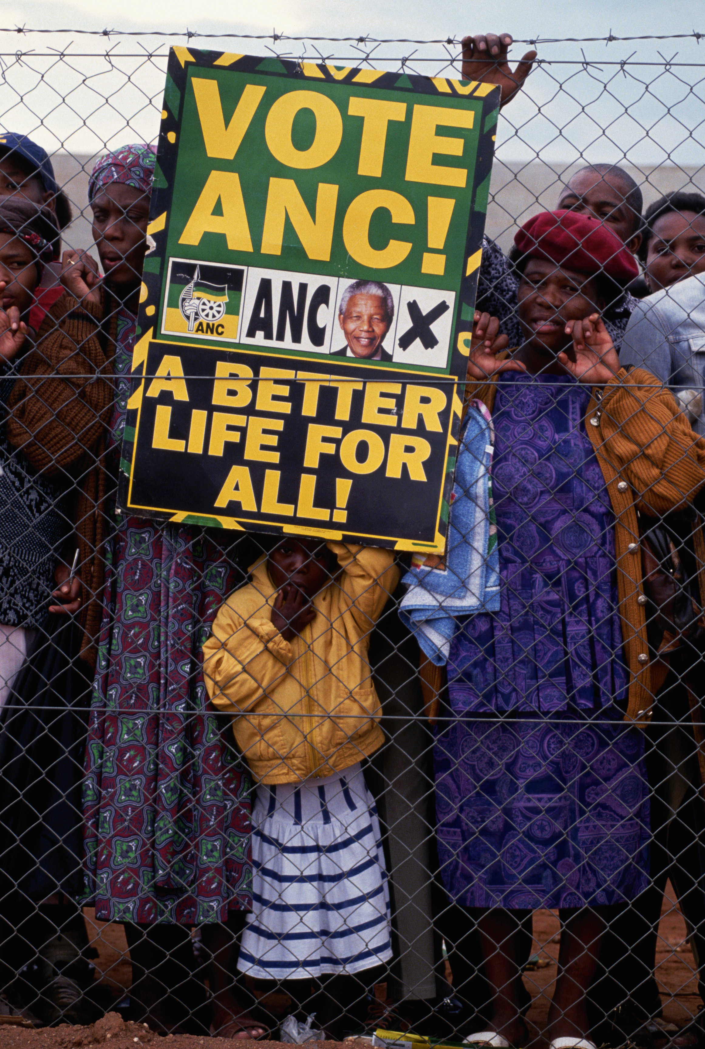 Supporters of Nelson Mandela and the African National Congress gather at a campaign rally before South Africas first democratic election. (Photo by Peter Turnley/Corbis/VCG via Getty Images). 1994