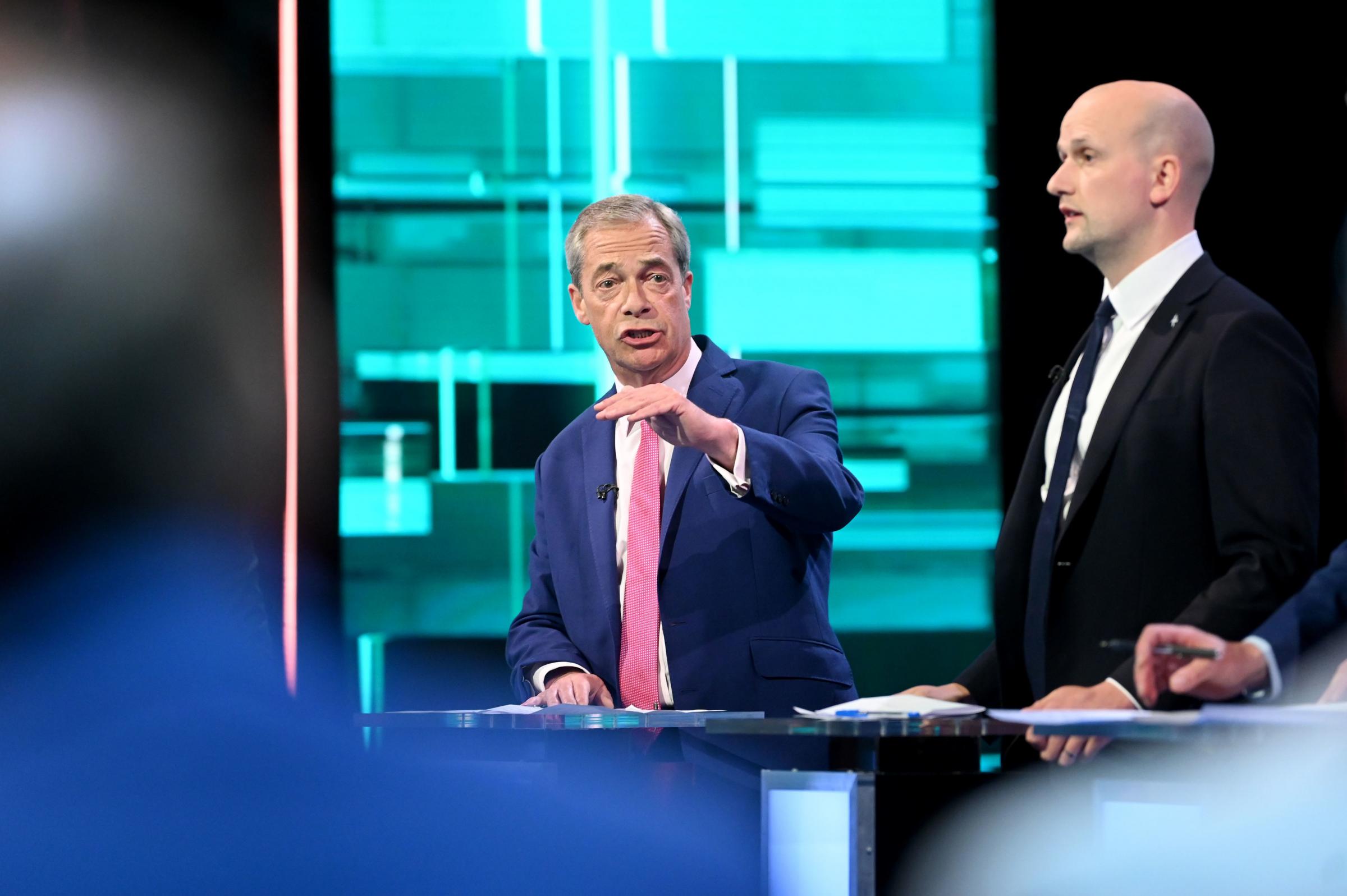 NO USE AFTER THURSDAY JULY 4, 2024. EDITORIAL USE ONLY Handout photo provided by ITV of (left-right) Reform UK leader Nigel Farage and Stephen Flynn of the SNP taking part in the ITV Election Debate hosted by ITV news presenter Julie Etchingham, at