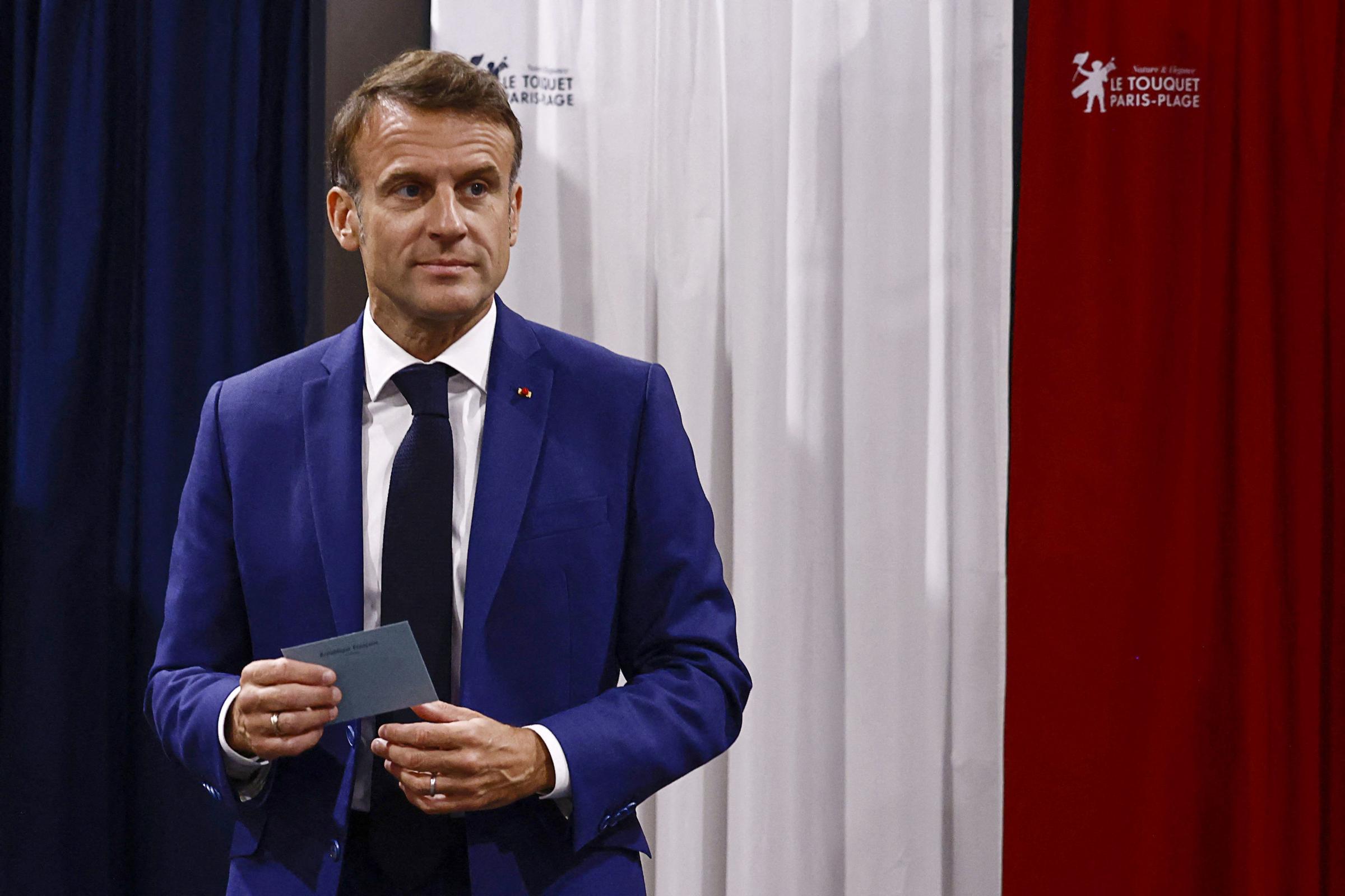 French President Emmanuel Macron leaves the voting booth before voting in the early French parliamentary election, in Le Touquet-Paris-Plage, northern France, Sunday, June 30, 2024. France is holding the first round of an early parliamentary election