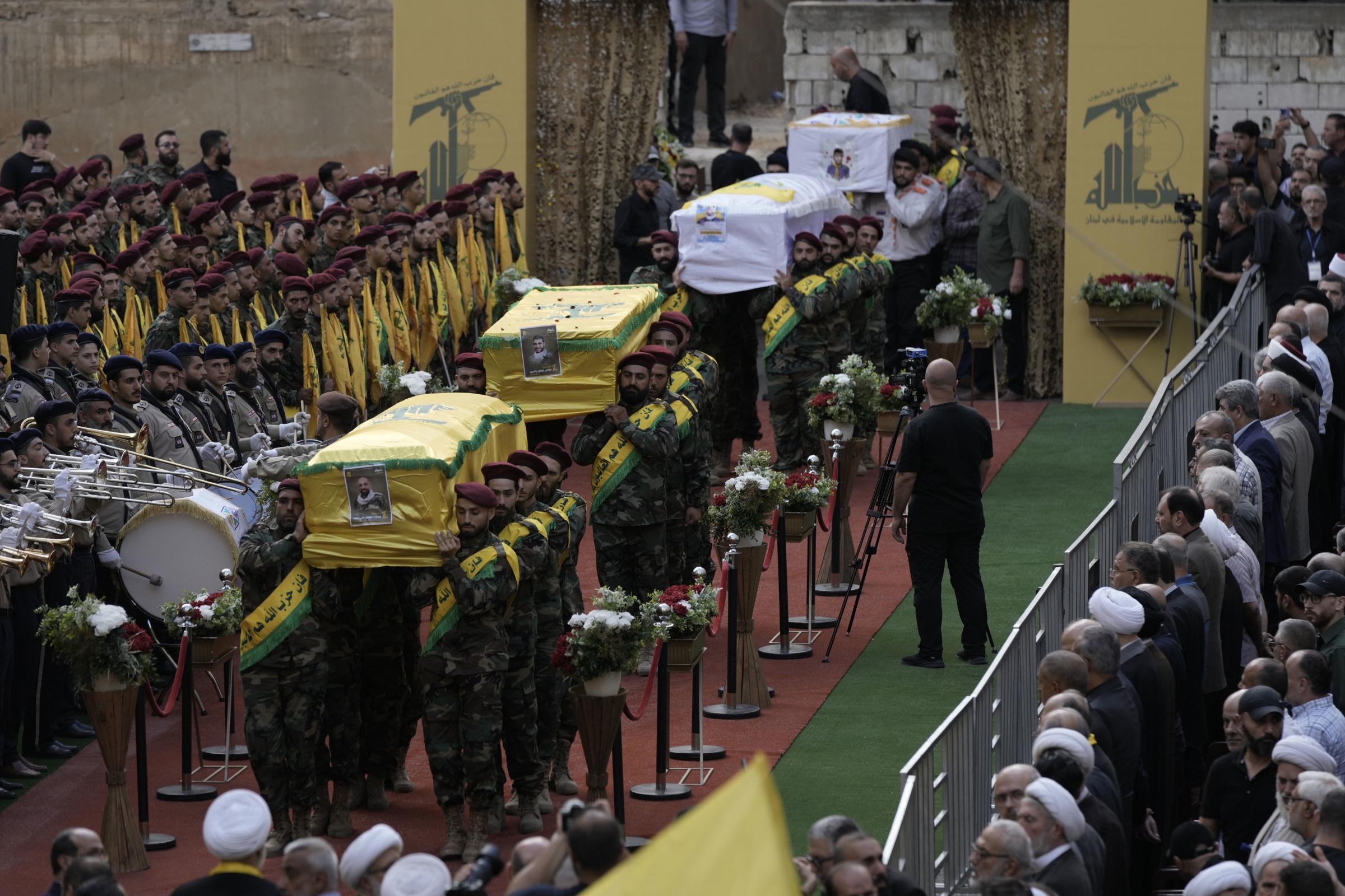 CORRECTS DAY TO TUESDAY WHEN KILLED Hezbollah fighters carry the coffins of fallen four comrades who were killed Tuesday after their handheld pagers exploded, during their funeral procession in the southern suburb of Beirut, Lebanon, Wednesday, Sept. 18,