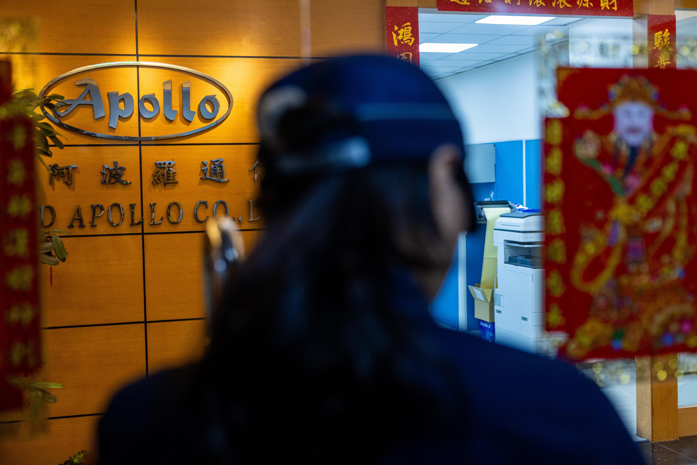 NEW TAIPEI CITY, TAIWAN - SEPTEMBER 18: A police officer attempts to enter the office of Gold Apollo on September 18, 2024 in New Taipei City, Taiwan. Pager bombings across the Middle East have sparked new widespread worries about spiralling violence in