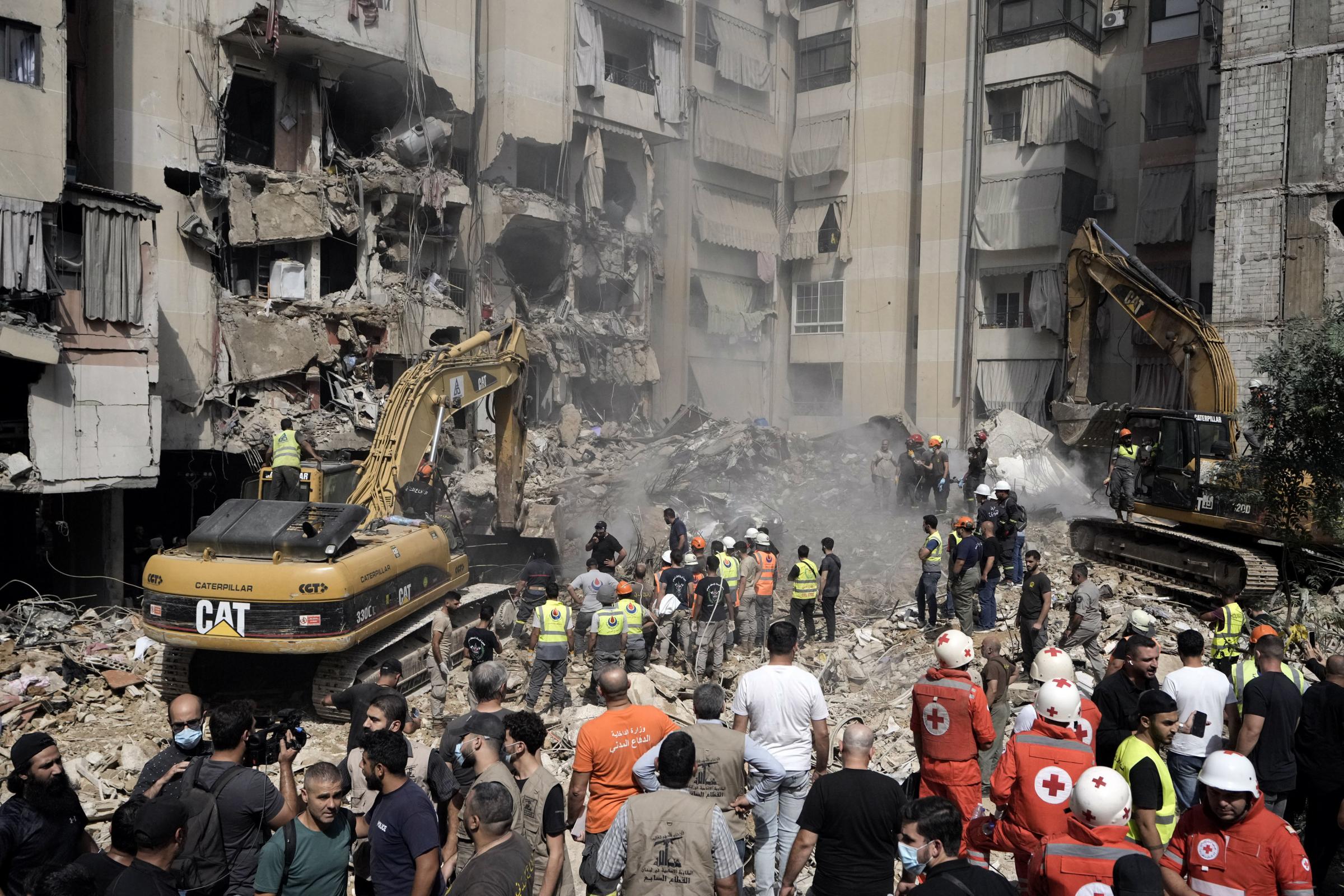 Emergency workers use excavators to clear the rubble at the site of Fridays Israeli strike in Beiruts southern suburbs, Saturday, Sept. 21, 2024. (AP Photo/Bilal Hussein).