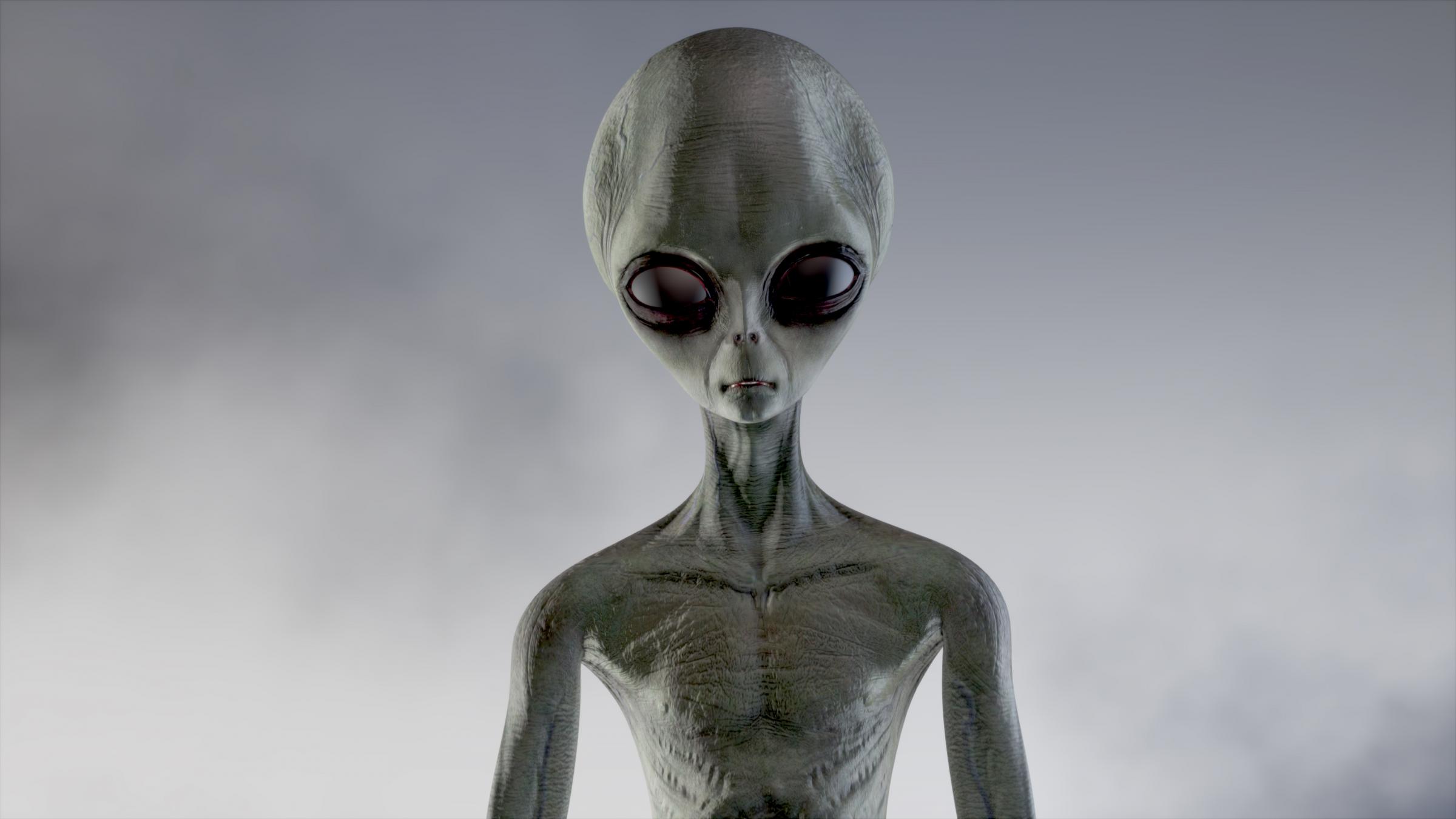 Scary gray alien walks and looks blinking on a dark smoky background. UFO futuristic concept. 3D rendering