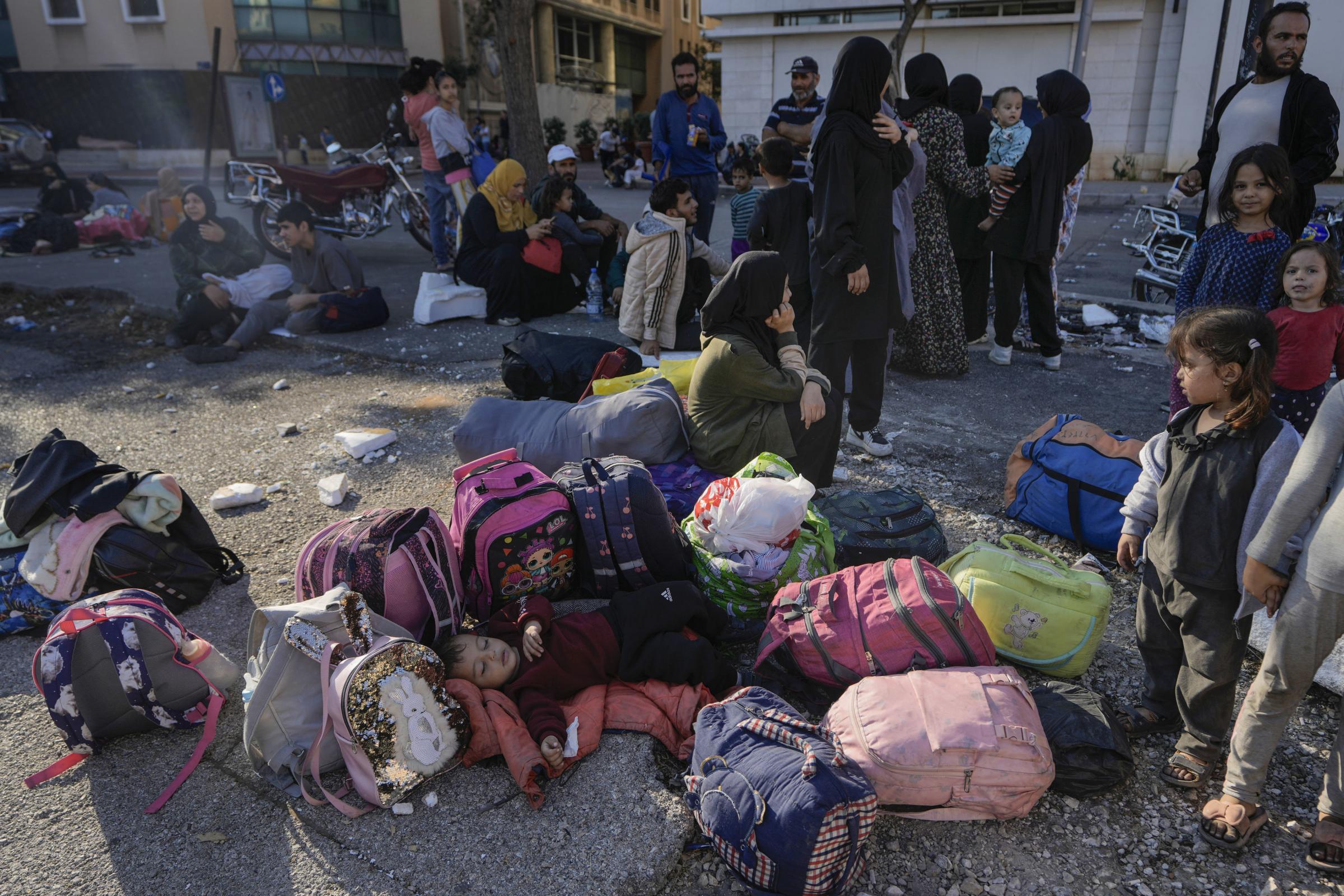 Families gather in Martyrs square after fleeing the Israeli airstrikes in Beiruts southern suburbs, Saturday, Sept. 28, 2024. (AP Photo/Bilal Hussein) 