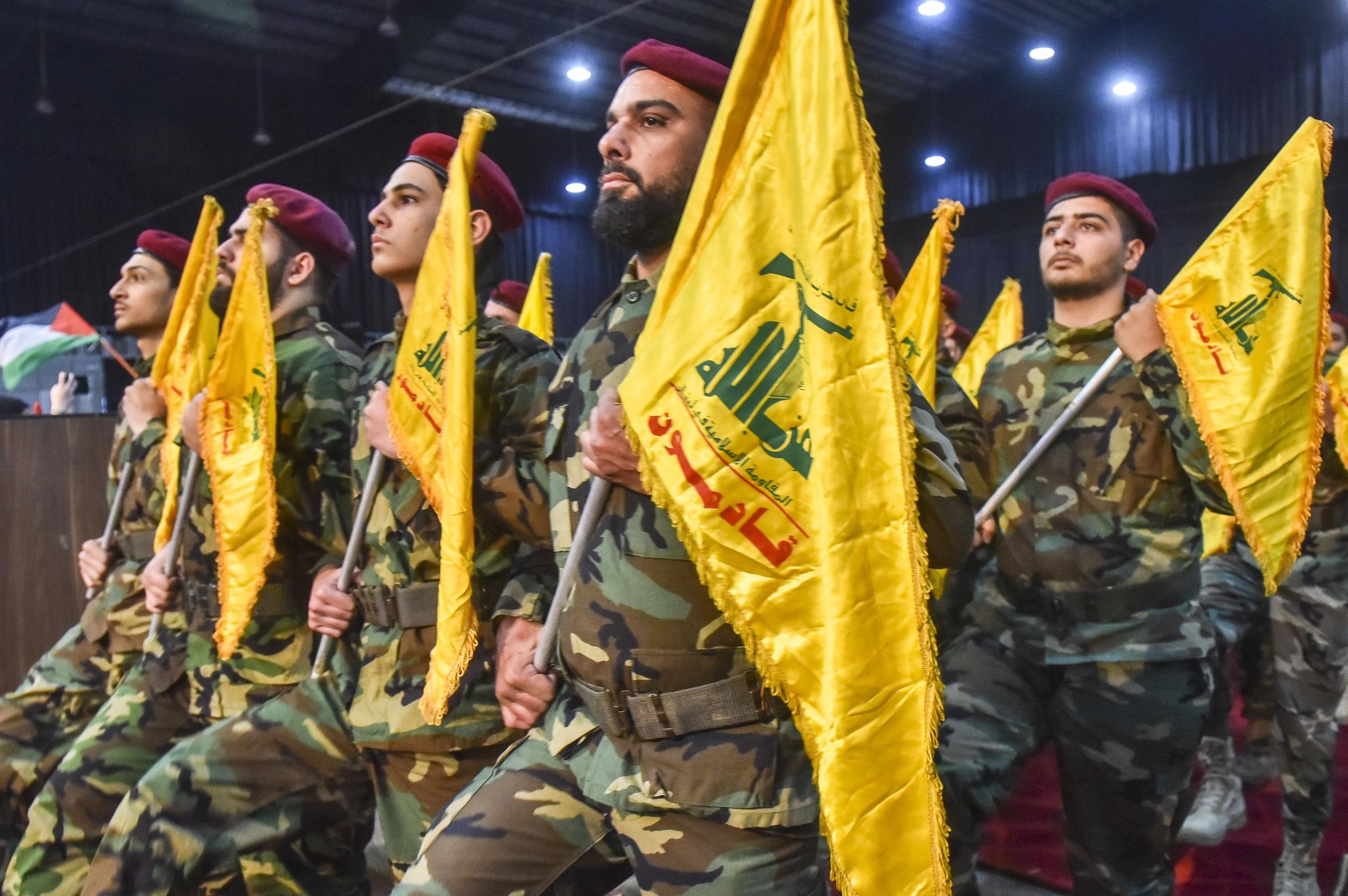 Supporters of the Shiite movement Hezbollah, wave party flags in Beiruts southern suburbs on April 14, 2023, as they gather to mark Al-Quds (Jerusalem) Day, a commemoration in support of the Palestinian people celebrated annually on the last Friday of