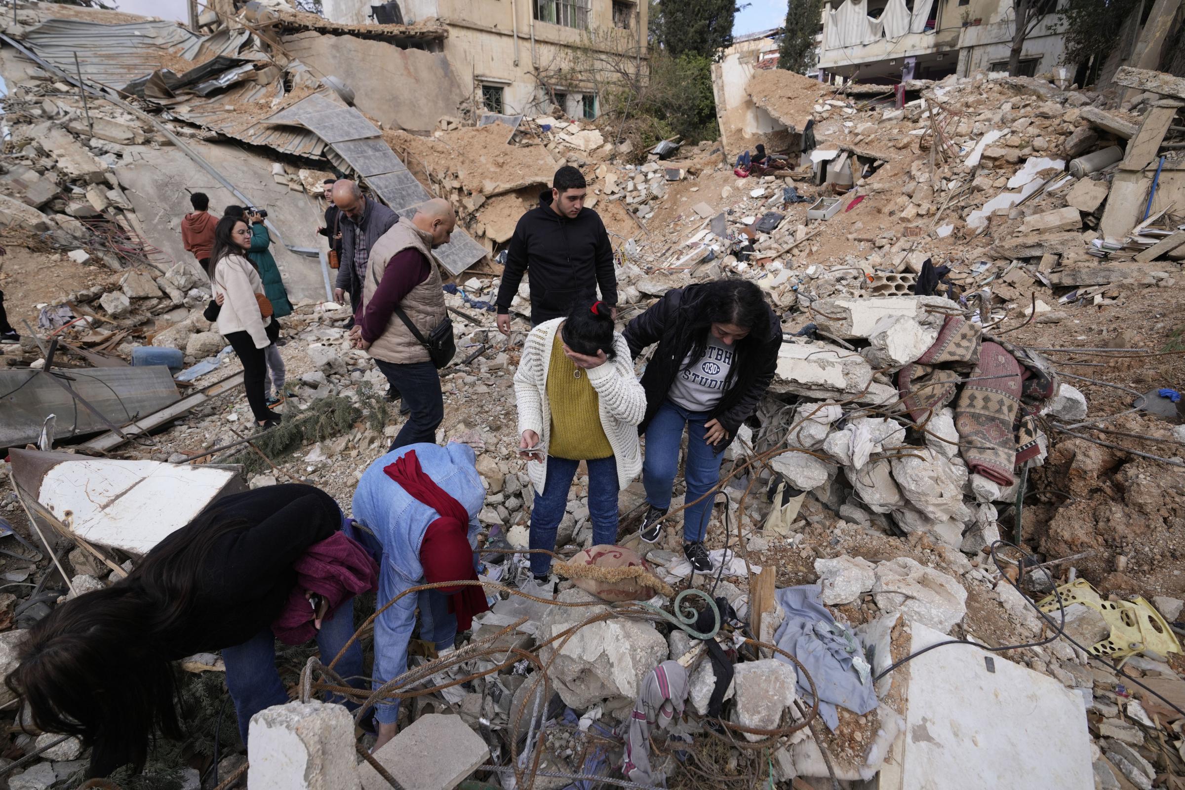 Displaced residents react as they stand in front of the rubble of their destroyed house in Baalbek, eastern Lebanon, Thursday, Nov. 28, 2024. (AP Photo/Hassan Ammar).