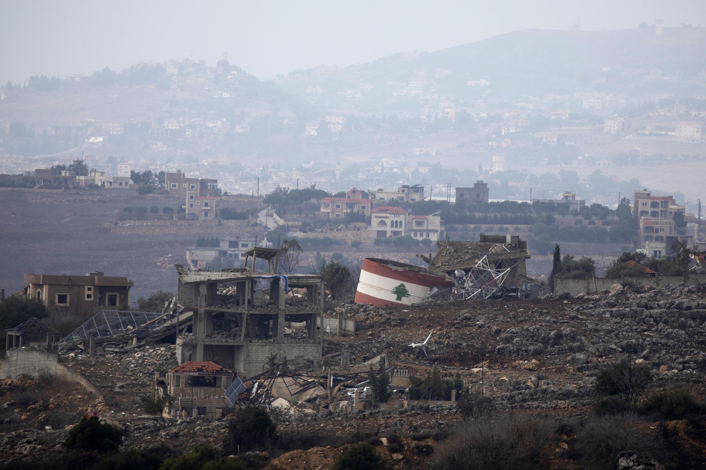 NORTHERN ISRAEL, ISRAEL - NOVEMBER 27: The flag of Lebanon is painted on a destroyed structure in the village of Weiss El Jabal as seen from a position on the Israeli side of the border in Northern Israel on November 27, 2024. Israeli Prime Minister